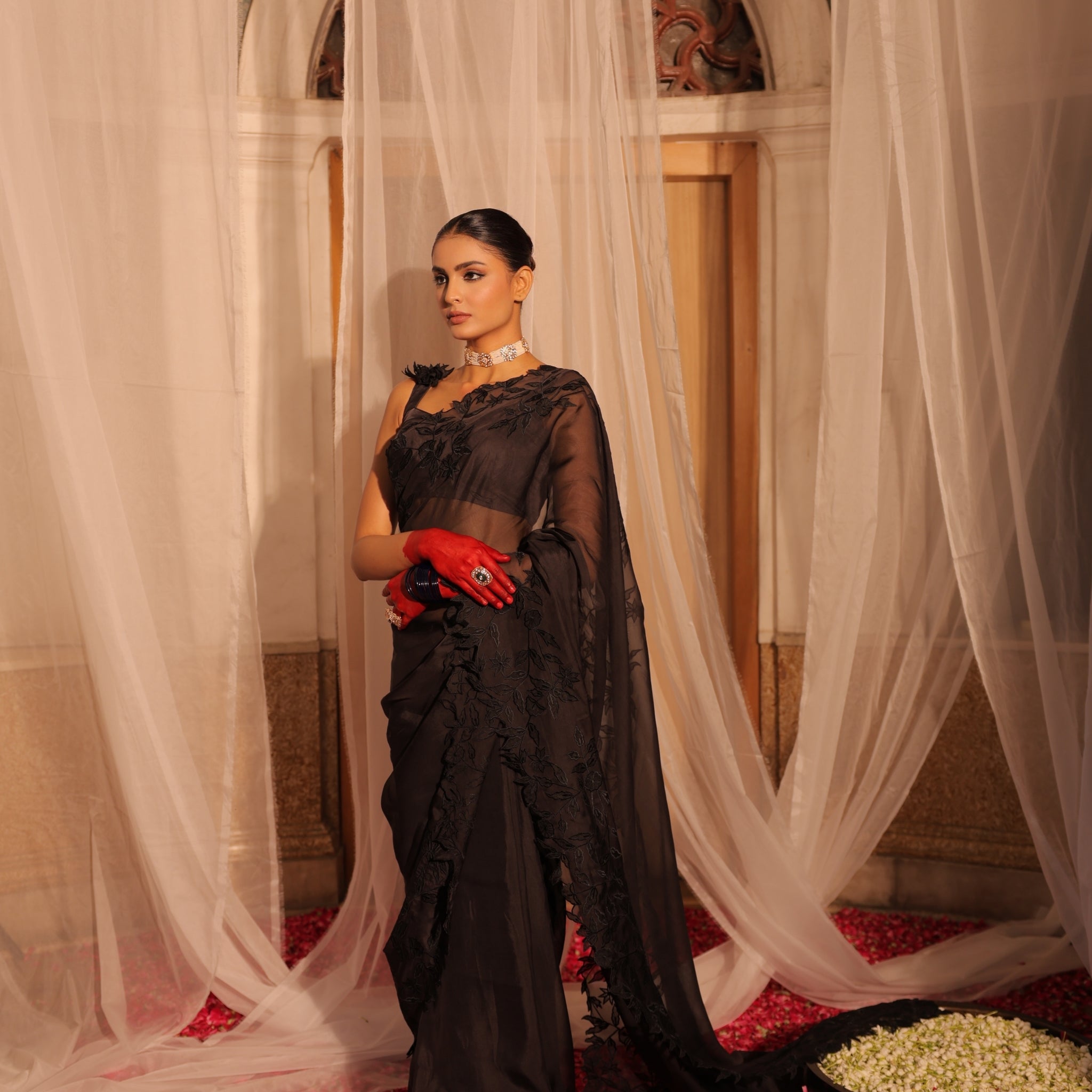 Elegant Black Organza Saree with Heavy Appliqué Work and Sleeveless Blouse with Flower Brooch