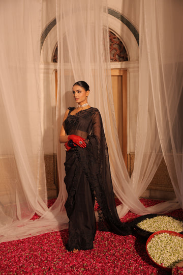 Elegant Black Organza Saree with Heavy Appliqué Work and Sleeveless Blouse with Flower Brooch