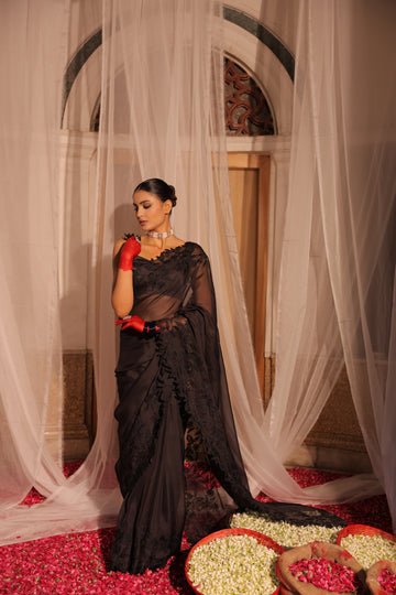 Elegant Black Organza Saree with Heavy Appliqué Work and Sleeveless Blouse with Flower Brooch